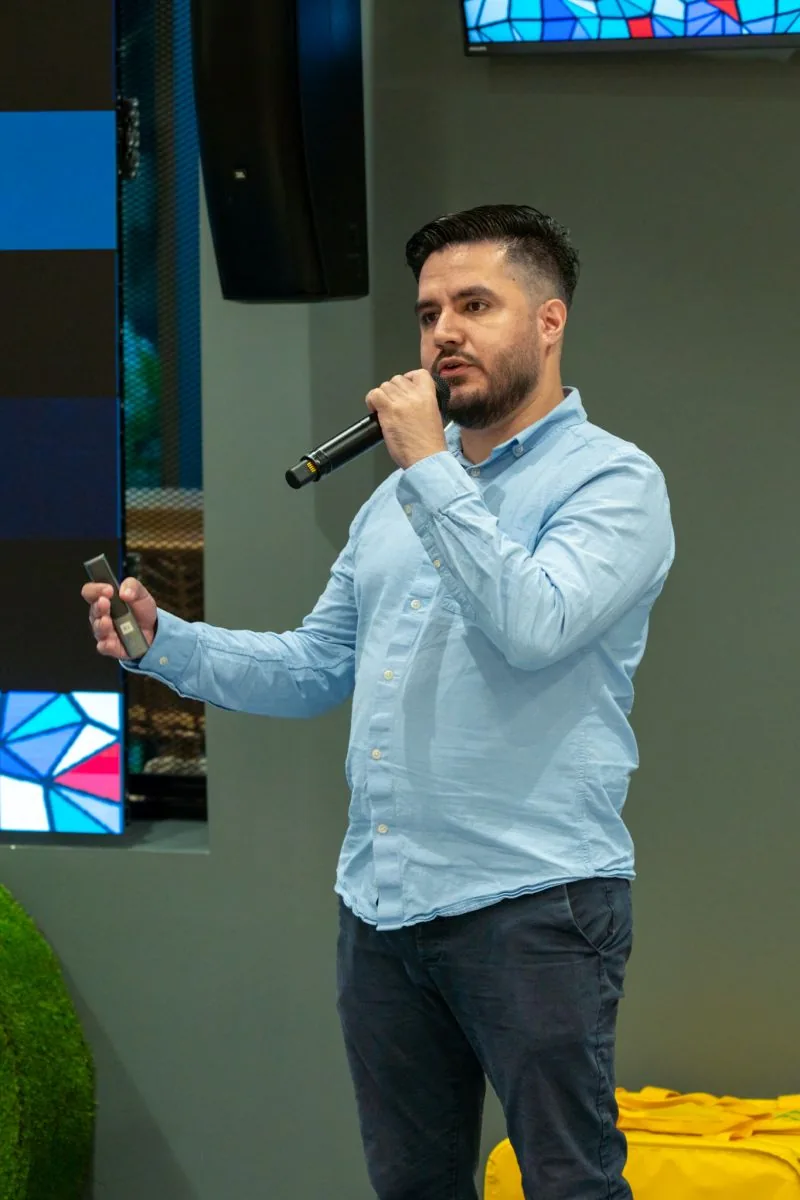 A speaker presenting with a microphone on the BAD Meetup stage