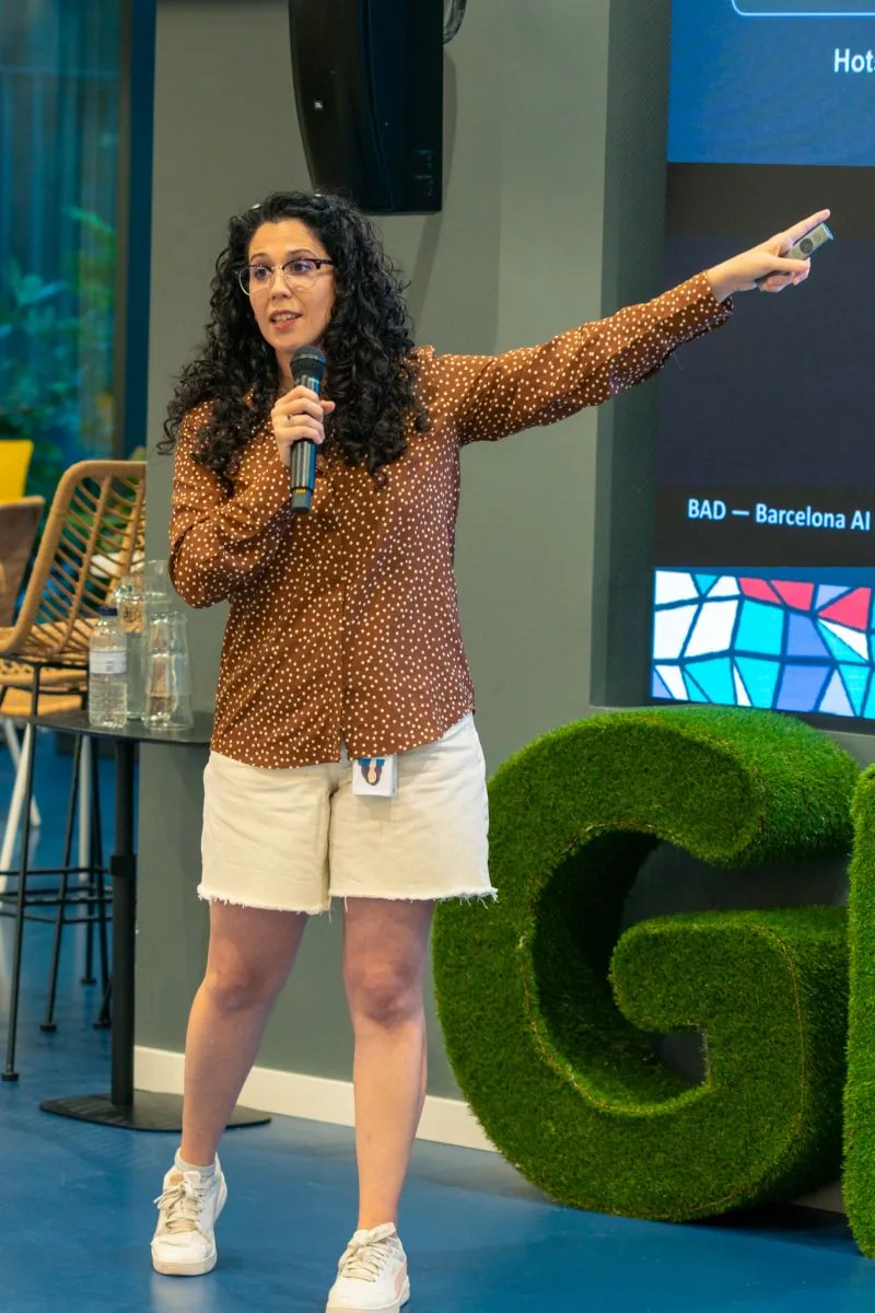 A speaker presenting beside the Glovo stage display