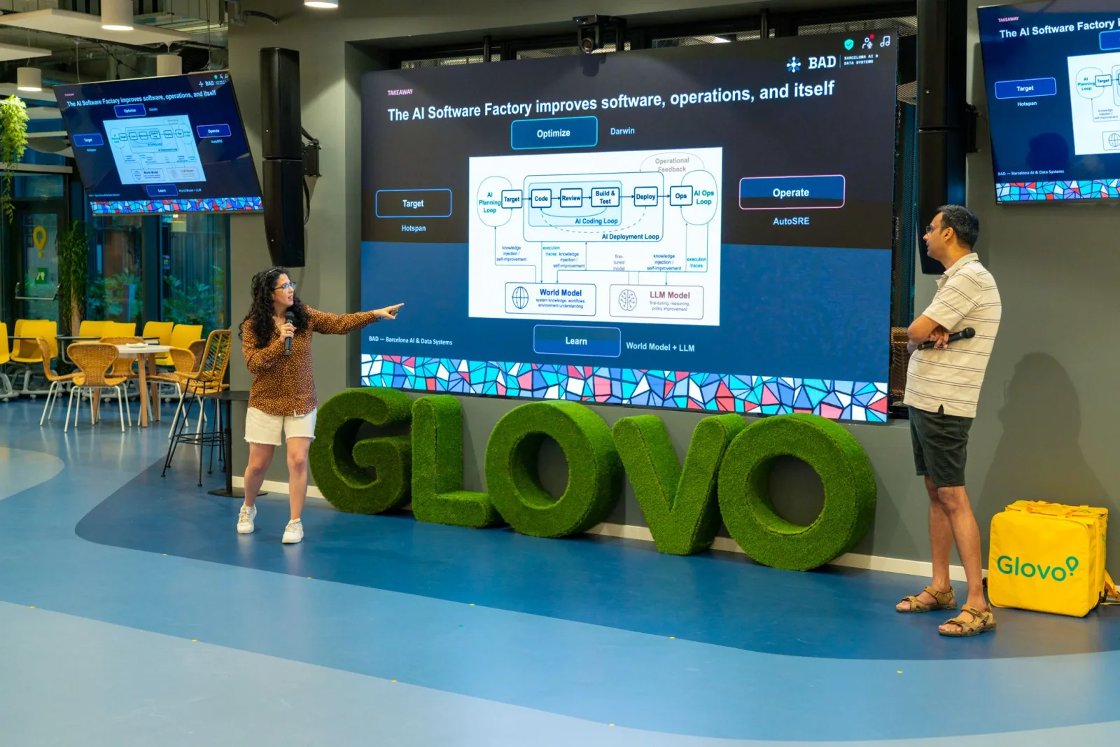 Two speakers discussing an AI Software Factory for data systems