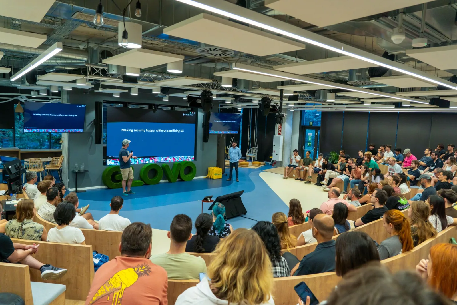 A full room watching a technical talk at BAD Meetup #2 in Glovo Yellow Park